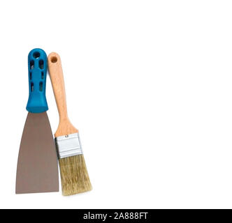 Metal spatula, trowel with plastic handle and paint brush on white background with copyspase Stock Photo