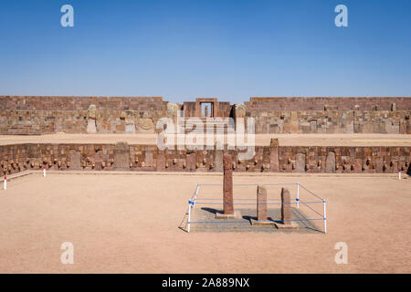 Semi-underground Temple with the Kalasasaya Temple and Ponce monolith shown in the background at Tiwanaku Archeological Complex, Bolivia Stock Photo