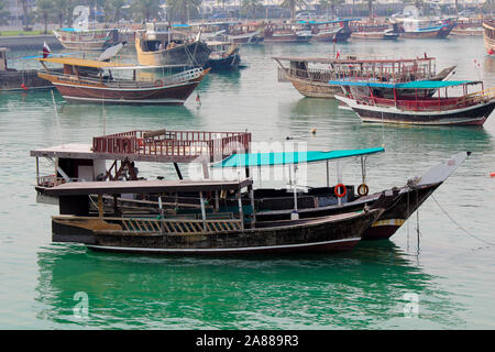 Traditional boats called Dhows are anchored in the port near the Museum of Islamic Art Park, Doha , Qatar. Traditional Arabian wooden boat dhow Stock Photo