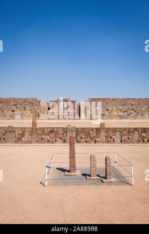 Semi-underground Temple with the Kalasasaya Temple and Ponce monolith shown in the background at Tiwanaku Archeological Complex, Bolivia Stock Photo