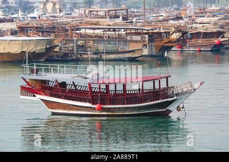 Traditional boats called Dhows are anchored in the port near the Museum of Islamic Art Park, Doha , Qatar. Traditional Arabian wooden boat dhow Stock Photo