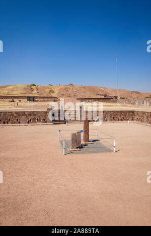 Semi-underground Temple with the Akapana pyramid in the background at Tiwanaku Archeological Complex, Bolivia Stock Photo