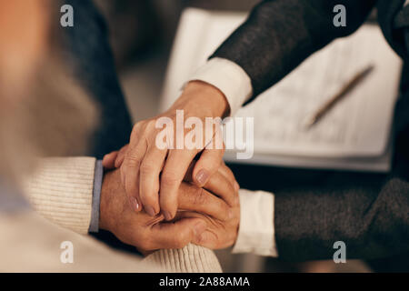 Close-up of woman holding hands with the man and supporting him in difficult situation Stock Photo