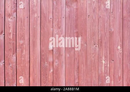 Wooden background, rustic fence with nails and knots painted red brown paint Stock Photo
