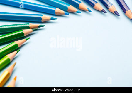 Green and blue pencils are arranged in a semicircle with a place for text Stock Photo