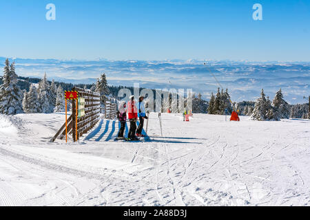 Kopaonik, Serbia - January 20, 2016: Ski resort panoramic view, ski slope, people skiing down the hill, mountains panorama Stock Photo