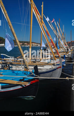 Moored old type sailing boats in the marine during sunny day Stock Photo