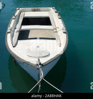 Small oar fishing boat on the water close-up Stock Photo