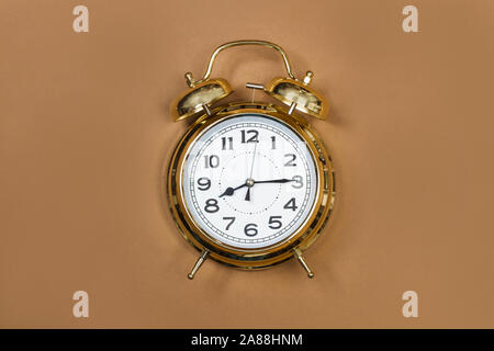 Old alarm clock on a brown background Stock Photo