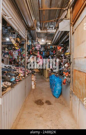 Rissani, Morocco - September 18th, 2019: Shoes shop stall inside Rissani bazaar market, in the city center of Rissani, Morocco. Stock Photo