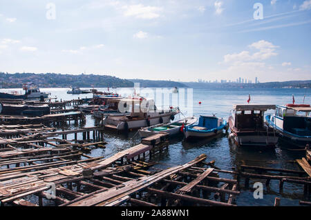 Old piers on the sea, with wrecked and usable boats Stock Photo