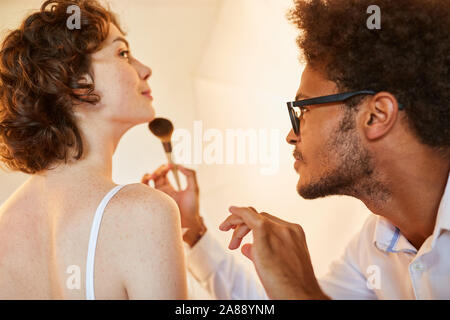 Make-up artist makes up a photo model for a photo shoot for portrait photos Stock Photo