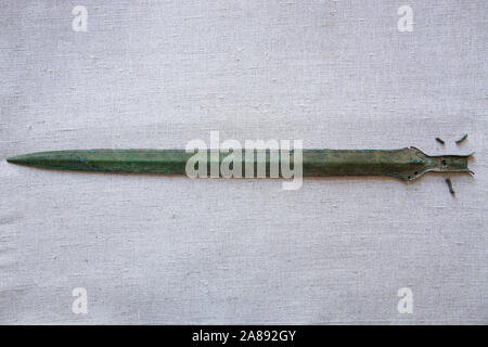 An Early Bronze age sword (pictured) made of bronze was found at random on Saturday, November 2, 2019, Rychnov museum archaeologist Martina Bekova said on Thursday, November 7, 2019, in Rychnov nad Kneznou, Czech Republic. The weapon is decorated with a simple engraved line around the blade, still sharp as a razor, Bekova said, calling the find exceptional. 'The bronze grip tongue sword is dated to around 1200 B.C. It is part of the Lusatian culture. The finds of this culture are numerous in eastern Bohemia, but it is not so in the case of swords,' Bekova said. (CTK Photo/David Tanecek) Stock Photo
