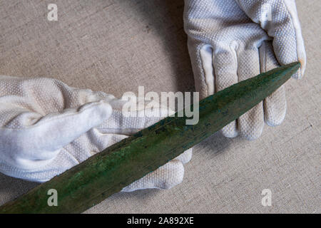 An Early Bronze age sword (pictured) made of bronze was found at random on Saturday, November 2, 2019, Rychnov museum archaeologist Martina Bekova said on Thursday, November 7, 2019, in Rychnov nad Kneznou, Czech Republic. The weapon is decorated with a simple engraved line around the blade, still sharp as a razor, Bekova said, calling the find exceptional. 'The bronze grip tongue sword is dated to around 1200 B.C. It is part of the Lusatian culture. The finds of this culture are numerous in eastern Bohemia, but it is not so in the case of swords,' Bekova said. (CTK Photo/David Tanecek) Stock Photo
