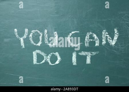 You can do it handwritten with white chalk on a green blackboardMotivation concept Stock Photo