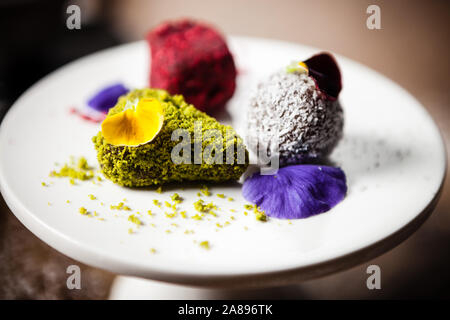 Vegan truffles dessert served on a plate in restaurant Stock Photo