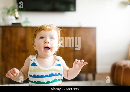 Baby boy looking up Stock Photo