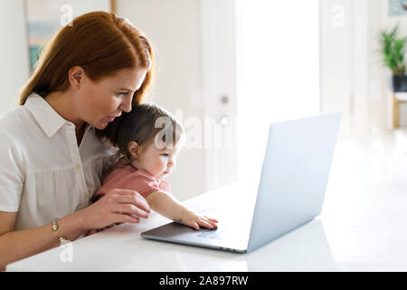 Mother and daughter using laptop Stock Photo