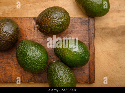 Avocados on cutting board Stock Photo