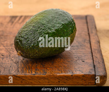 Avocados on cutting board Stock Photo