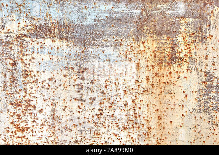 Painted steel sheet with faded and worn beige paint, with spots of corrosion or rust, abstract texture for the background. Stock Photo