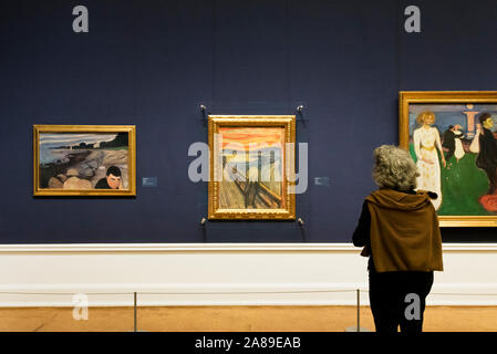 Visitor admiring the famous painting 'The Scream' by Edvard Munch. National Gallery (Nasjonalmuseet) in Oslo. Norway Stock Photo