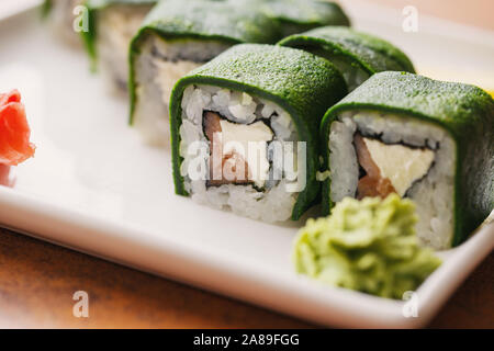 Traditional Japanese cuisine. Sushi with salmon and cheese are ready to be served. Delicious Japanese food. Stock Photo
