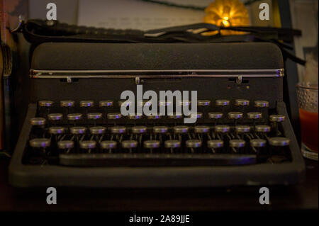 An old-fashinoned typewriter in a dimly it room Stock Photo
