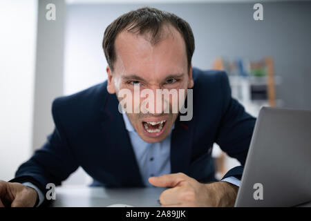 Stressed Young Businessman Screaming In The Office Stock Photo