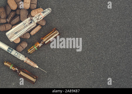 Ampoules and pills on table. Patient treatment in hospital Stock Photo