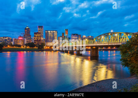 Skyline of Portland, Oregon, USA at dusk, with Willamette River and Hawthorne Bridge