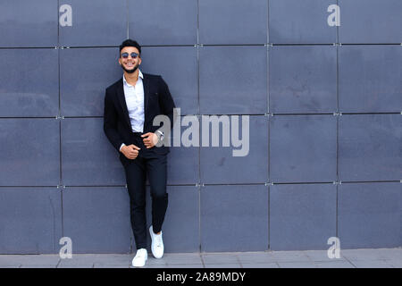 Arabic guy in business center stands smiling walking slow Stock Photo