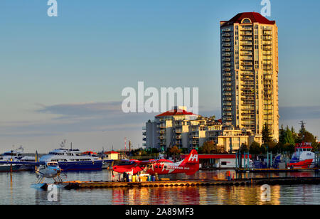 A landscape view of the airplane dock at the Nanaimo harbour with the condo buildings in the background at sunset Stock Photo