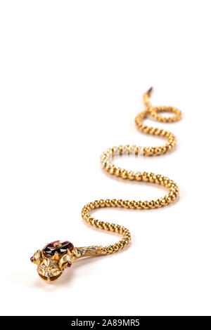 Victorian gold snake necklace with a garnet head, ruby eyes and diamond topknot. Stock Photo