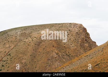 Red hills in canyon. Red colored rocks. Old bed of river in gorge Stock Photo