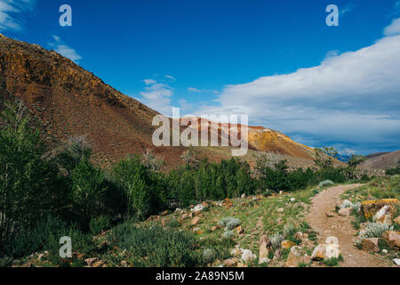 Rocks under blue sky. Sunny day in mountain valley. Colorful hills, Hiking in summer Stock Photo