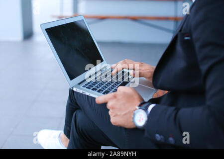 Cool guy arabic man uses laptop business center Stock Photo