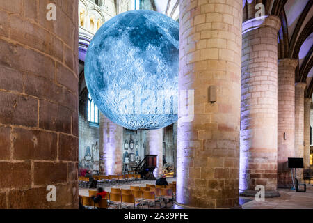 Artist Luke Jerram's Museum of the Moon (7 metres in diameter) in the nave of Gloucester Cathedral in October 2019 - Gloucester UK Stock Photo