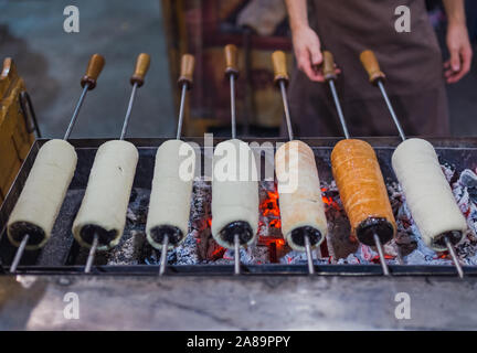 Preparation of the famous, traditional and delicious Hungarian Chimney Cake Stock Photo