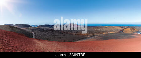 panoramic view of colorful volcanic landscape at Timanfaya National Park, montanas del fuego, on Lanzarote, Canary Islands against clear blue sky Stock Photo