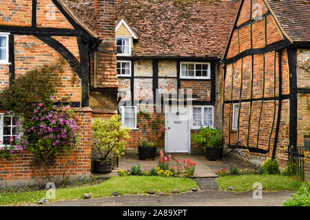 Red brick and roof tile tudor house with crooked wood beams of Church Cottage rectory at St Mary the Virgin in Turville village England Stock Photo