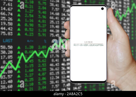 KONSKIE, POLAND - August 07, 2022: Smartphone displaying logo of LVMH Moet  Hennessy Louis Vuitton corporation on stock exchange chart background Stock  Photo