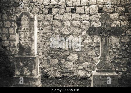 Graves in the cemetery at St Stephen Church, Zaton, Dalmatian Coast, Croatia Stock Photo