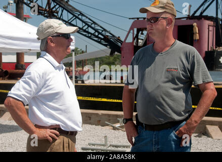 Magnolia Springs Mayor Charles Houser and Volunteer Fire Department Chief Jamie Hinton stand in front of a spud barge in Magnolia Springs, Alabama. Stock Photo