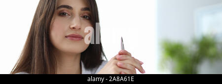 Cute woman holding pencil Stock Photo