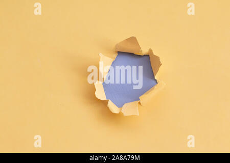 Damaged yellow paper with light blue background, space for text Stock Photo