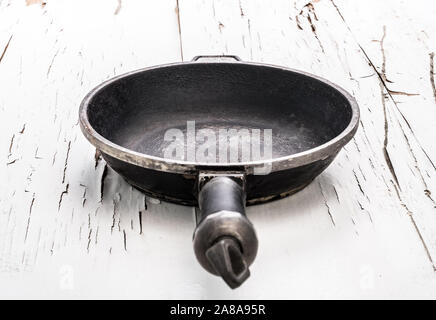 Empty cast iron frying pan on white background Stock Photo