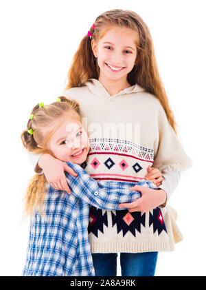 Two little girls sisters in casual clothes hugging Stock Photo