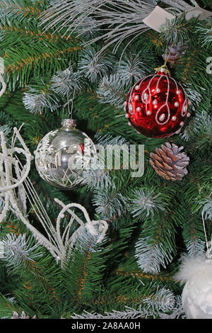 Real Christmas tree with red and silver decoration bulbs Stock Photo