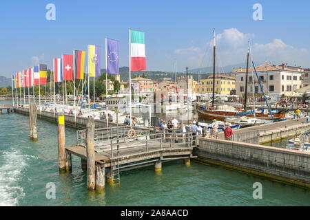 BARDOLINO, LAKE GARDA, ITALY - SEPTEMBER 2018: Ferry landing stage on the harbour wall in Bardolino on Lake Garda Stock Photo